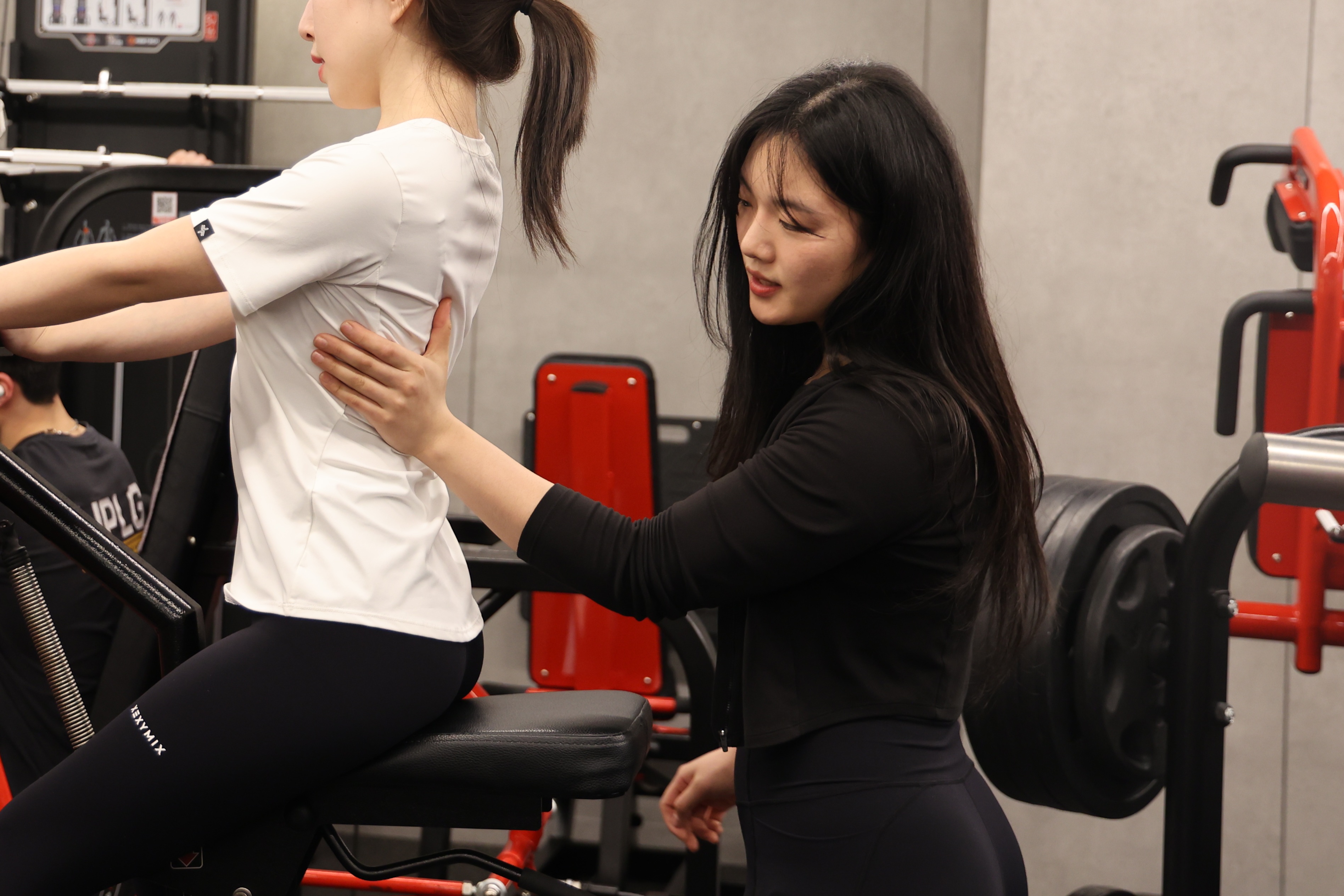 회원의 기구 운동 자세를 지도하는 한슬기 트레이너